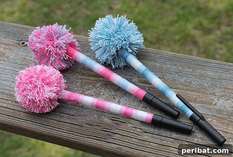 A collection of colorful pens, each topped with a playful, fluffy pom pom, adding a decorative touch.
