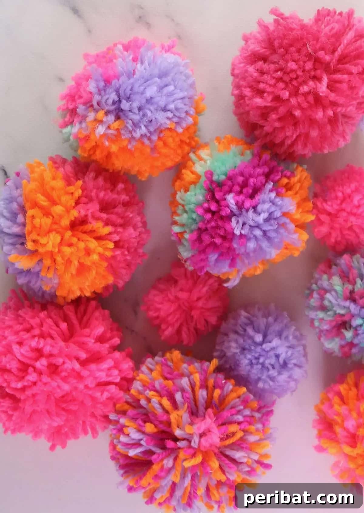 A display of various colorful, soft pom poms, highlighting different making techniques.