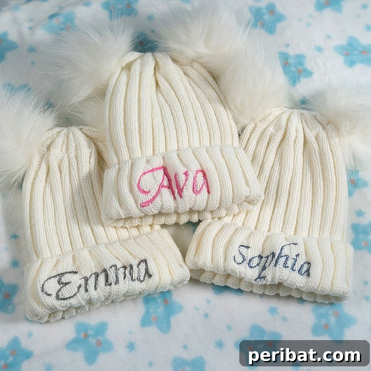 A cozy custom-made kid's hat featuring two fluffy pom poms at the top, adding a playful touch.