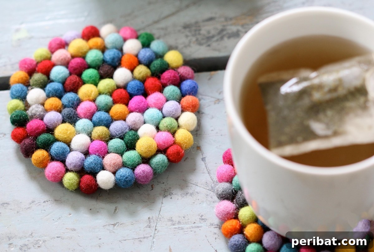Stylish and colorful DIY wool felt ball coasters, perfect for protecting surfaces.