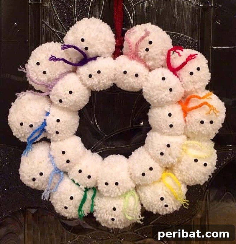 A charming snowman-shaped pom pom wreath, featuring white pom poms and festive accents.