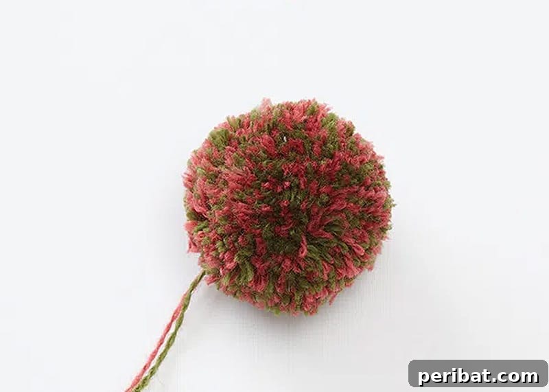A simple craft demonstrating how to make colorful pom poms using yarn and repurposed cardboard toilet paper rolls.