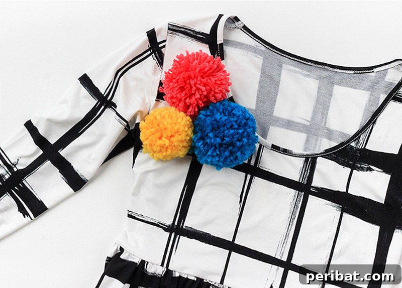 A collection of vibrant, unique pom pom brooches, adding a pop of color to any garment.