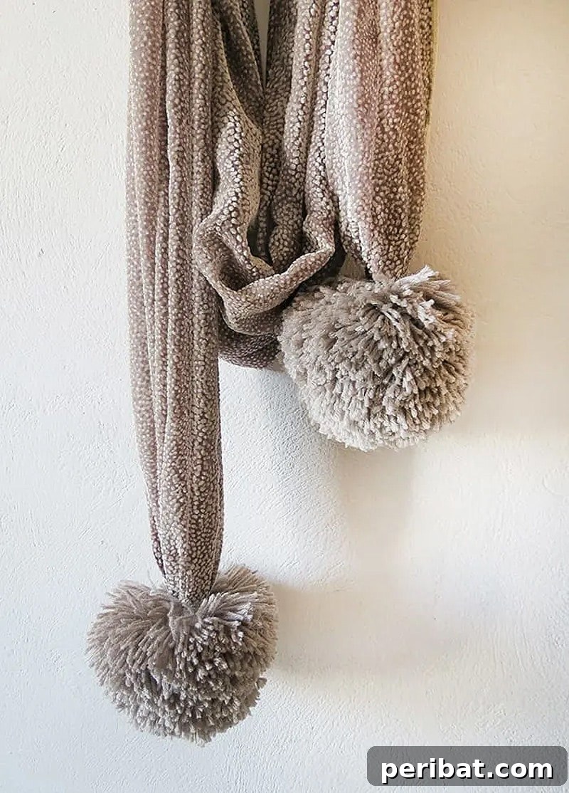 A selection of extra large, incredibly fluffy pom poms in soft, inviting colors, perfect for bold decor.