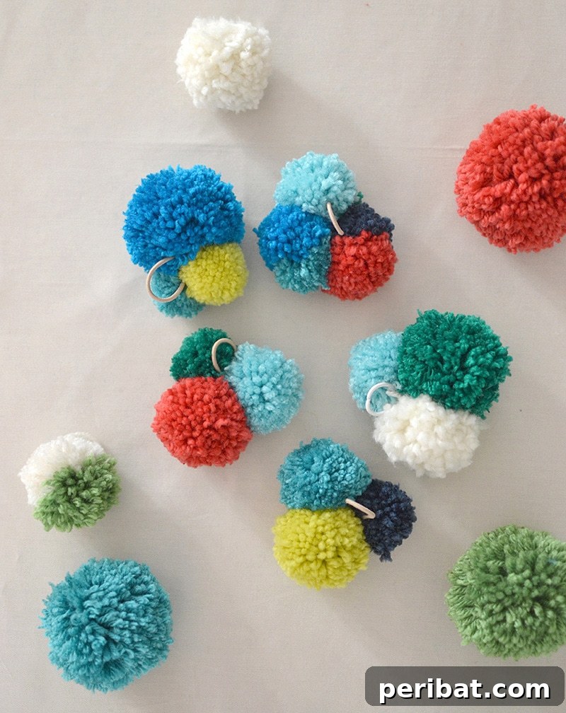 Elegant dining table setting featuring napkins secured with charming, small pom pom napkin rings.