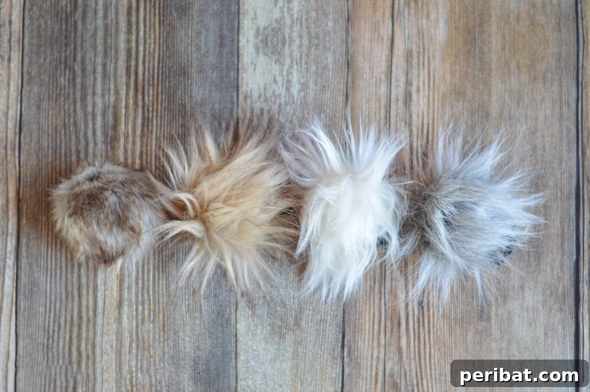 Luxurious, fluffy faux fur pom poms in various natural tones, showcasing their soft texture.