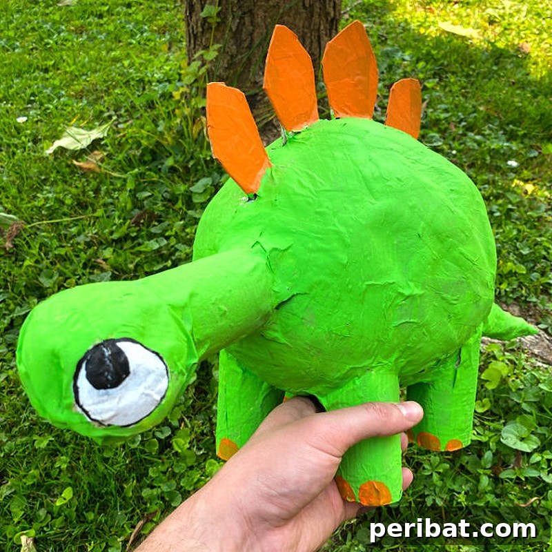 Whimsical paper mache dinosaur, ideal for stimulating creativity in kids