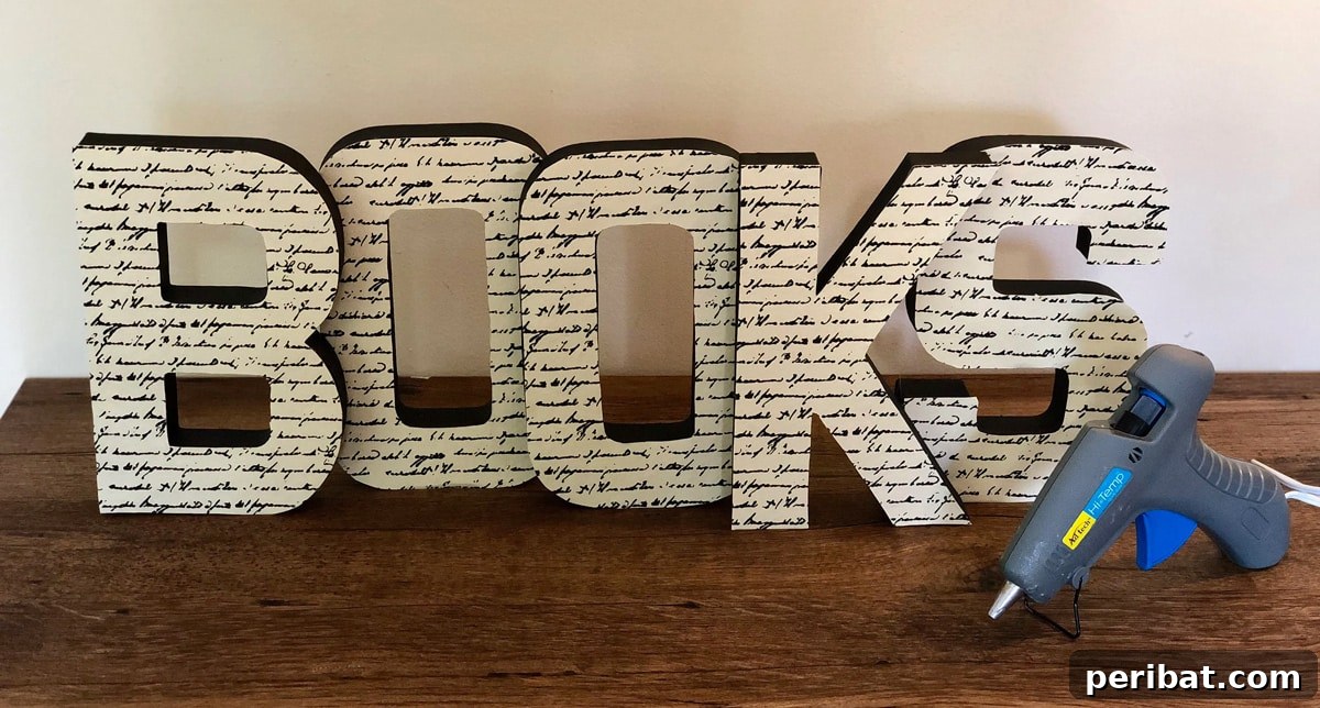 Personalized paper mache bookshelf sign created with paper mache letters and scrapbook paper