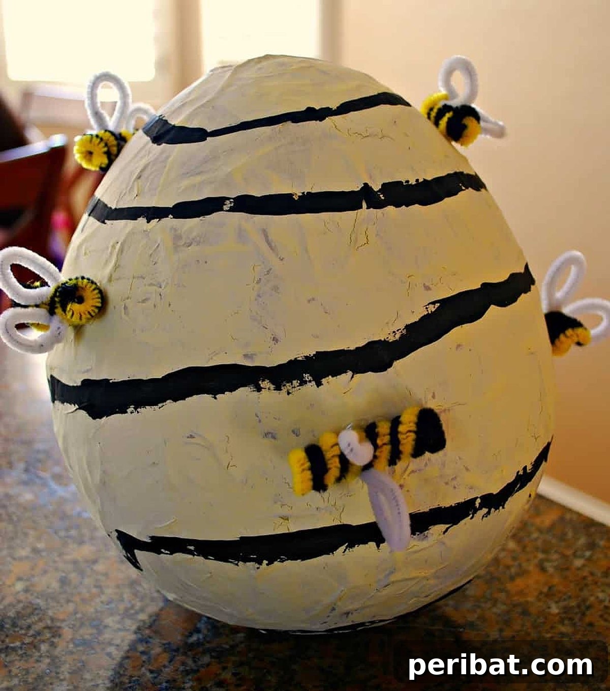 Playful DIY paper mache beehive, a perfect bumblebee costume accessory for children