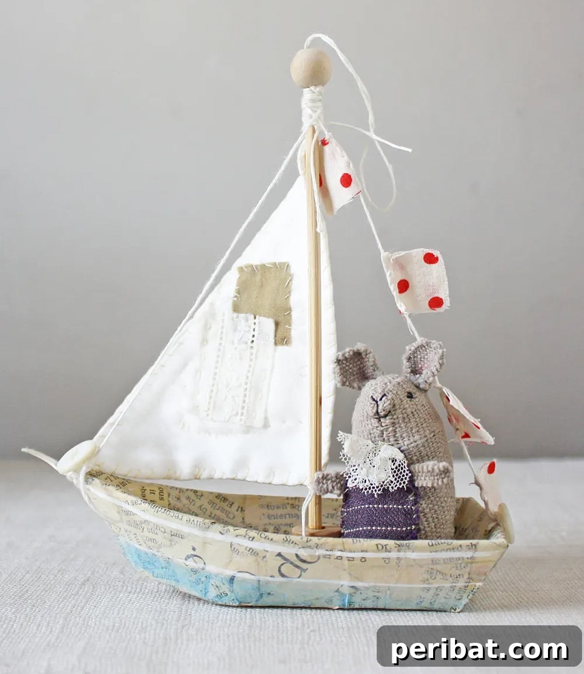Charming small boat ornament crafted with paper mache techniques, suitable for gifts or decor