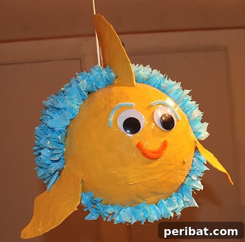 Charming paper mache fish pinata filled with fun treats and surprises