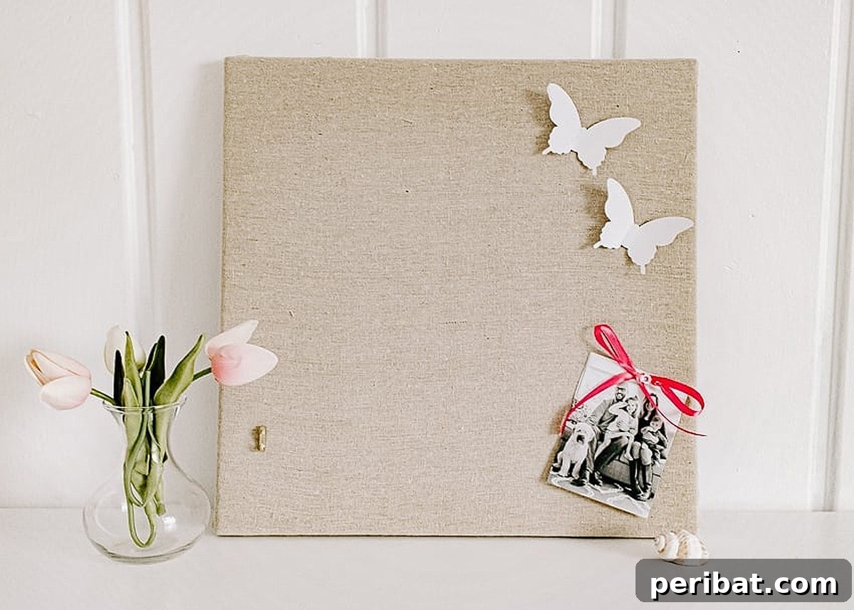27 Creative DIY Pinboard Projects 15 Stylish fabric pin board next to a flower vase, created in 4 easy steps