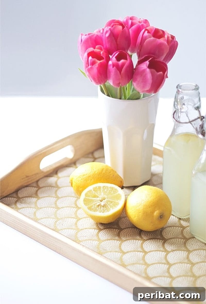 42 Creative DIY Serving Tray Projects 18 Trendy DIY stylish serving tray with gold edge and patterned paper interior, styled with lemon and flower vase