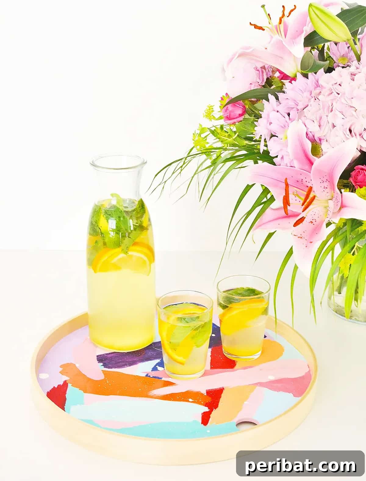 42 Creative DIY Serving Tray Projects 10 Abstract brushstroke art serving tray with intersecting colors, styled with glasses and a flower vase