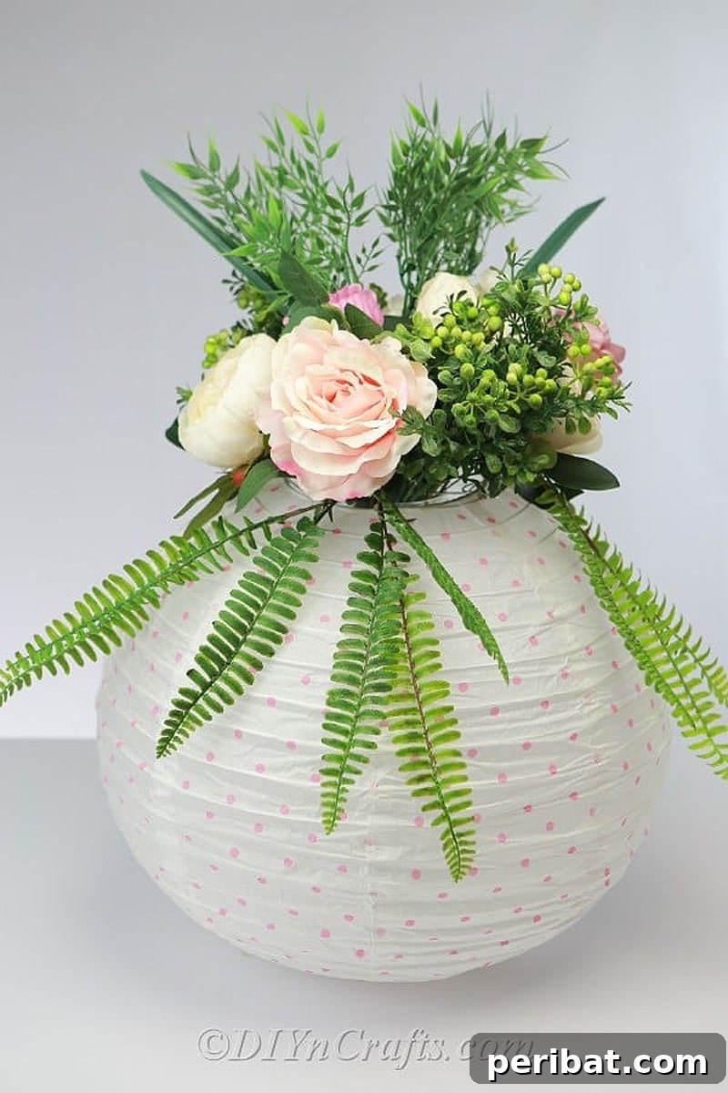Romantic paper lantern adorned with flowers for a wedding centerpiece