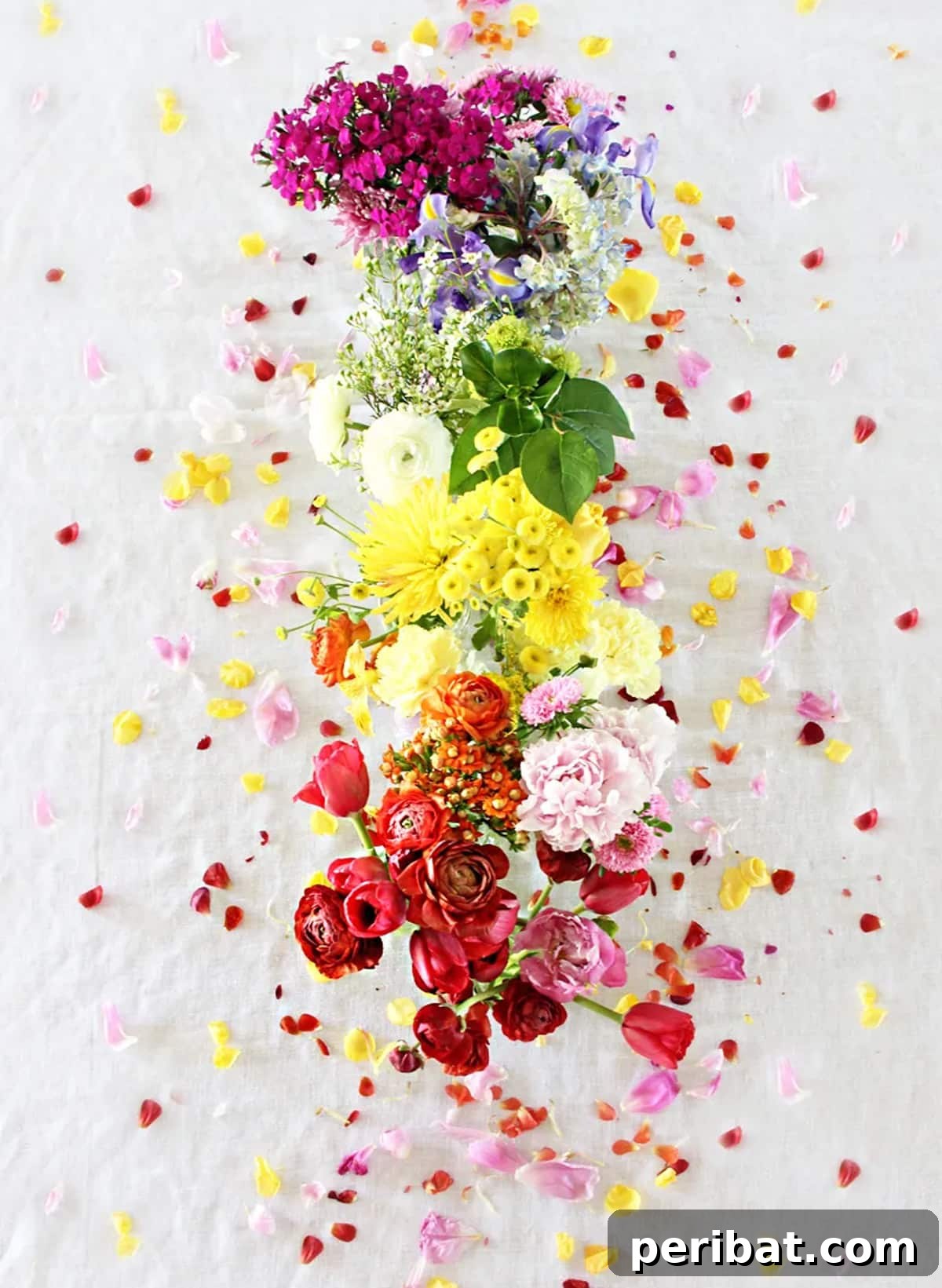 Whimsical DIY rainbow flowers centerpiece in small glass bottles
