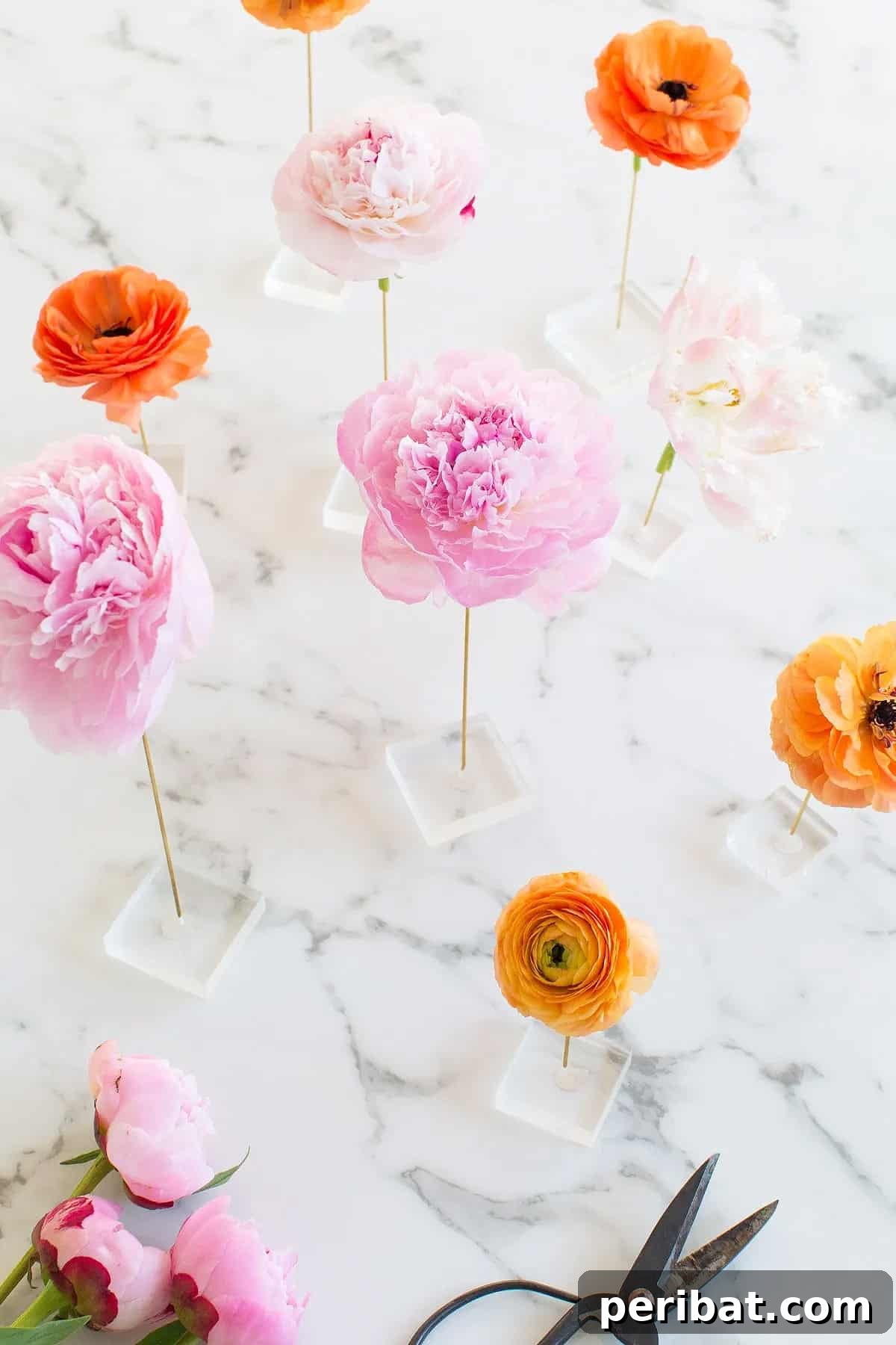 Innovative DIY floating flower table display with acrylic blocks and brass rods