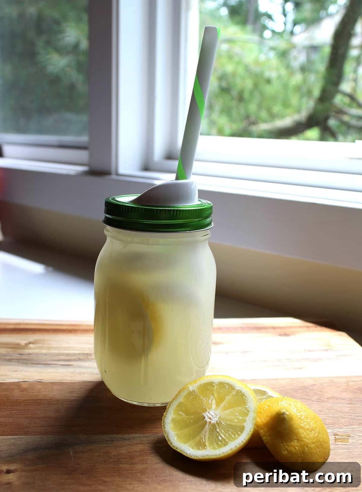 DIY Mason jar lemonade kit, complete with lemon slices, sugar, and a straw cap, perfect for summer party favors.