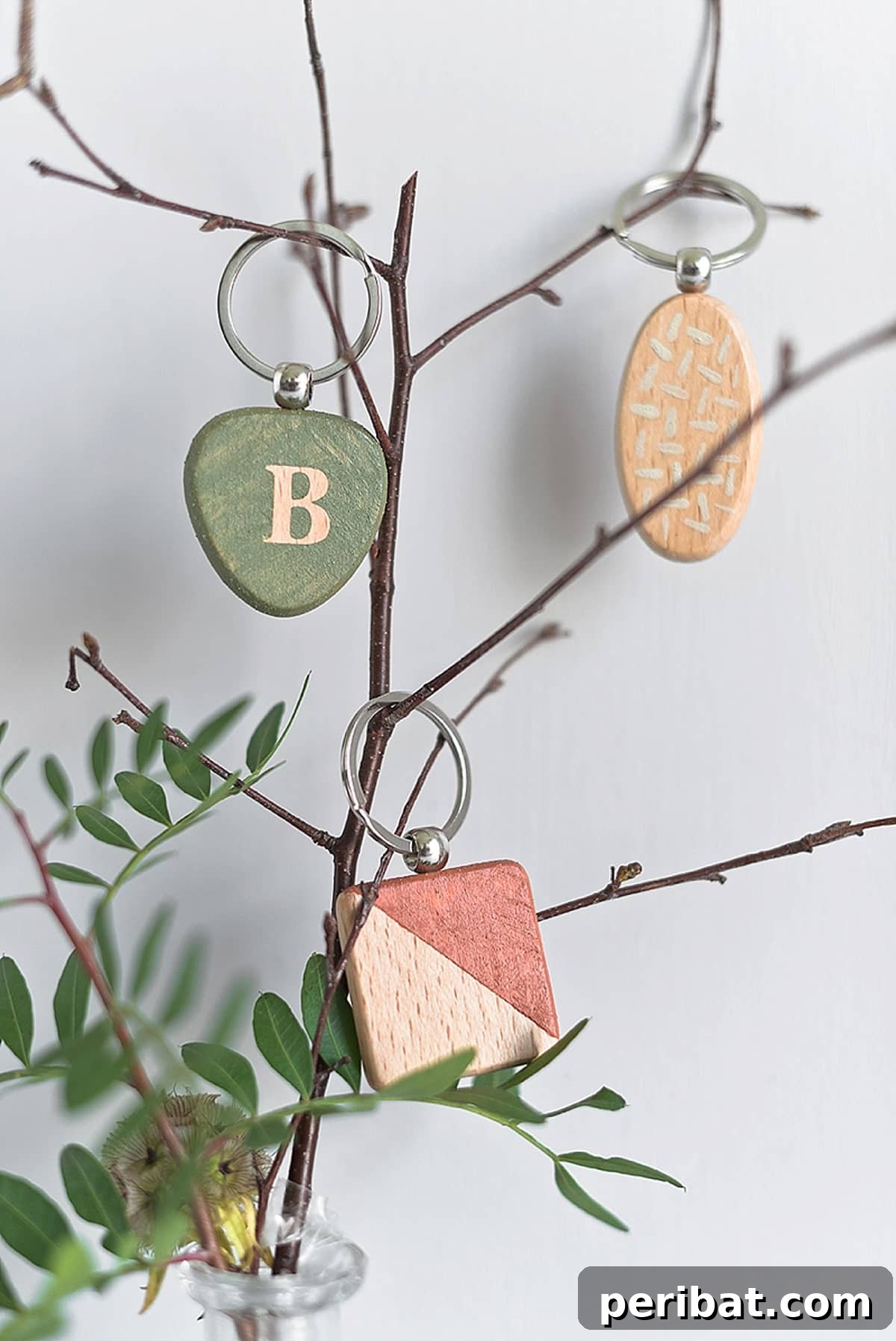 Botanical-inspired wedding favors crafted using DecoArt paints, showcasing elegant and personalized keychains.