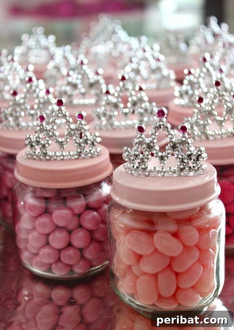 Charming princess crown party favors made from baby food jars, filled with pink candies and topped with crowns.