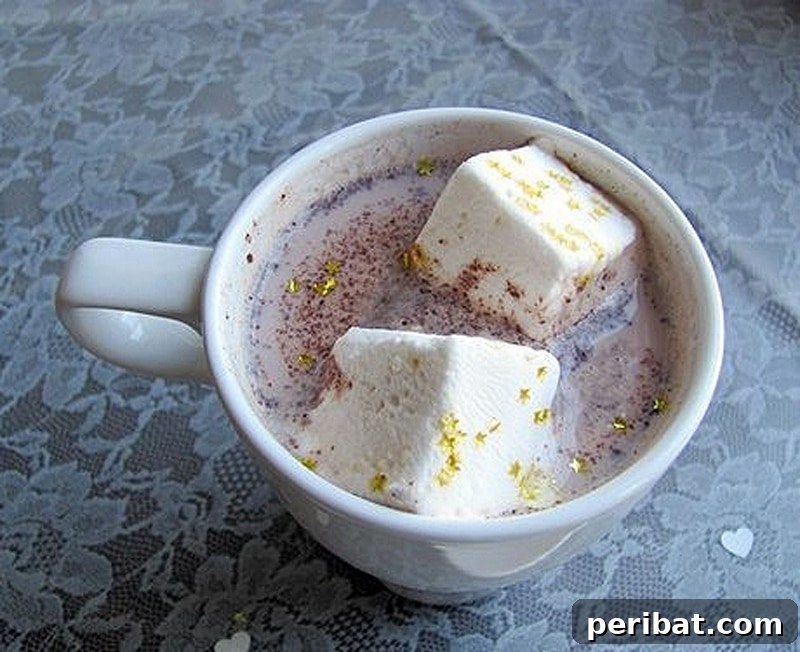 Homemade glitter marshmallows in a cup, a simple yet dazzling DIY party favor.