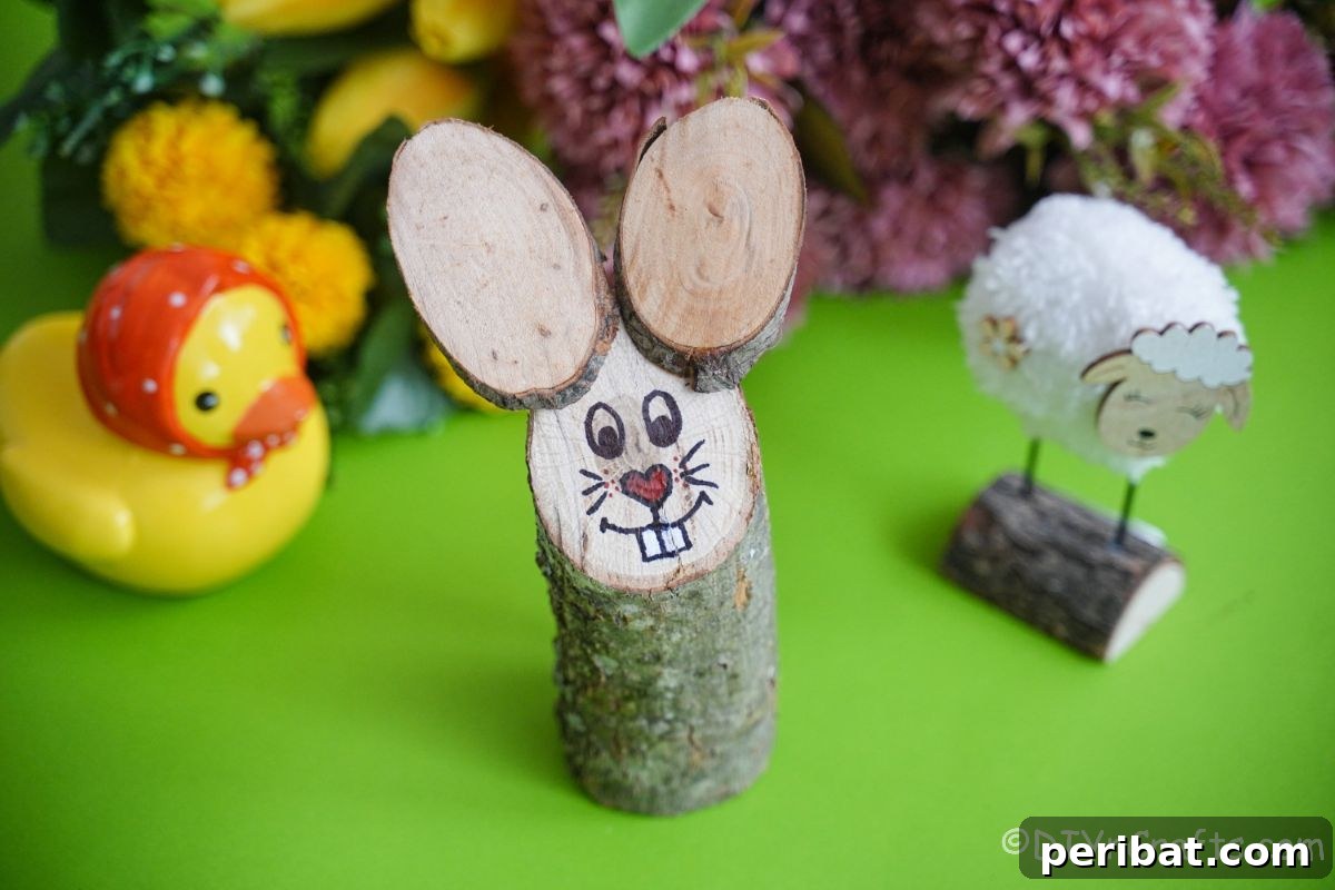 log bunny on green table with pom pom sheep and flowers in background