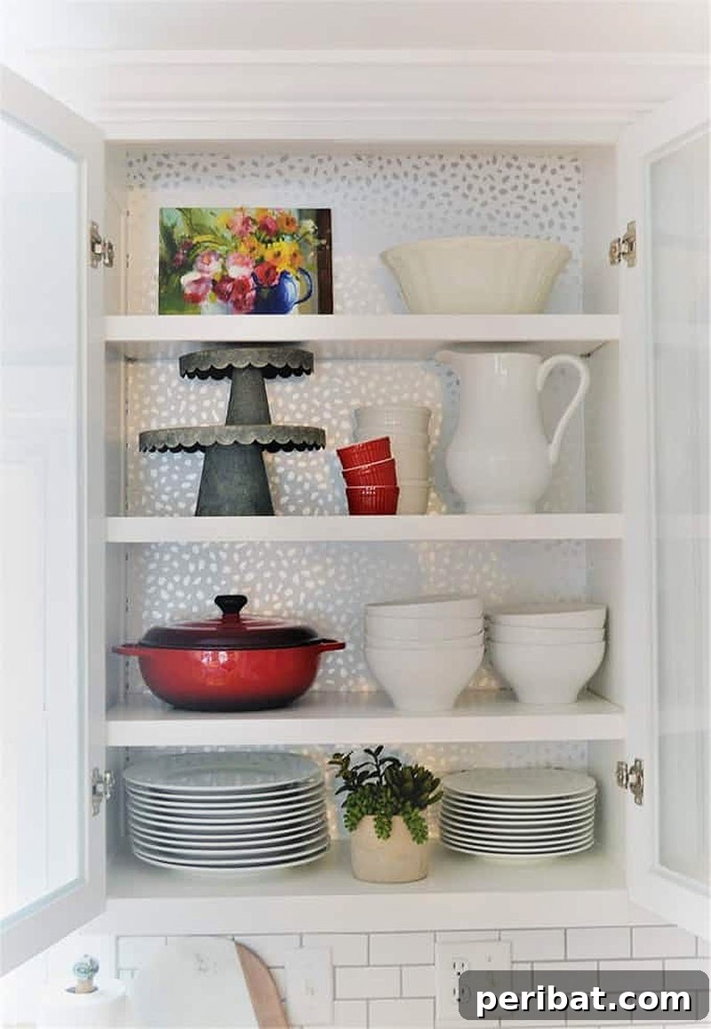 50 Smart DIY Home Improvement Hacks & Essential Products 44 Stylish kitchen cabinets adorned with removable wallpaper in Devine Color, demonstrating a quick and easy DIY kitchen makeover