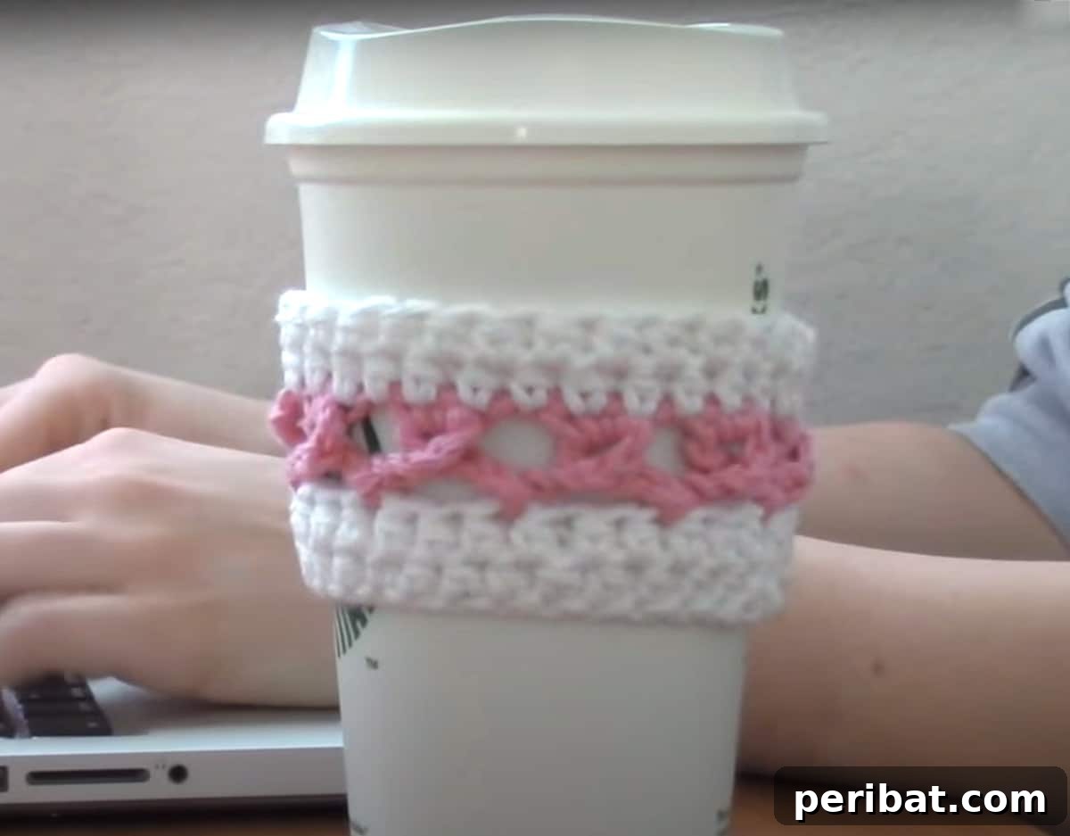 Meaningful pink ribbon themed crocheted coffee cozy, showing support for breast cancer awareness
