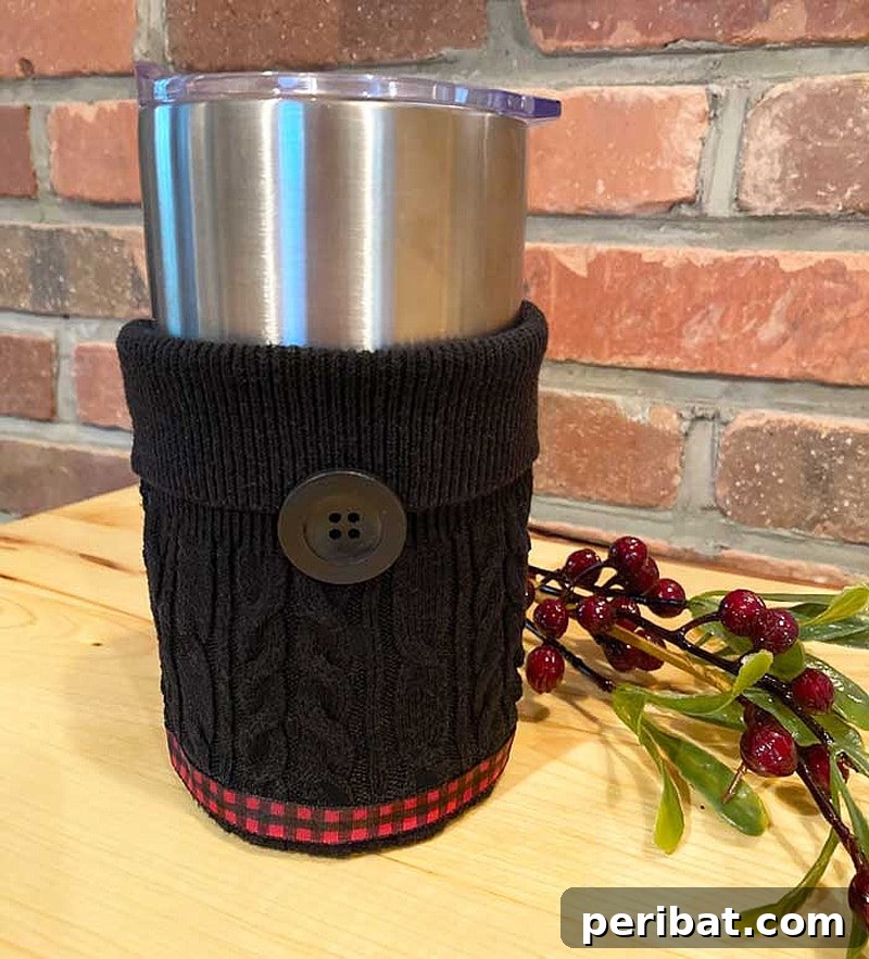 Cozy upcycled coffee sleeve made from a sweater sleeve, adorned with a ribbon and button