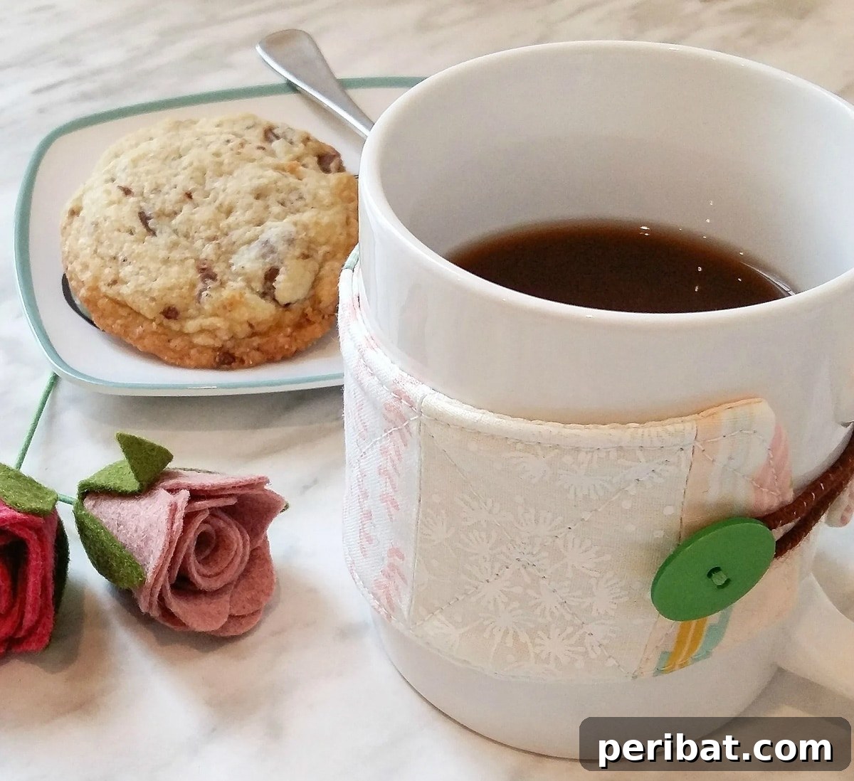 Colorful quilted fabric coffee sleeve, demonstrating a super easy sewing tutorial for fabric scraps
