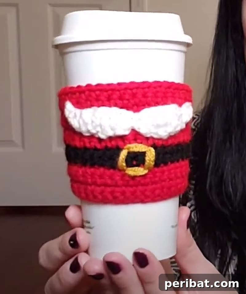 Festive Santa mustache and belt themed crocheted coffee cozy, ideal for holiday gifts