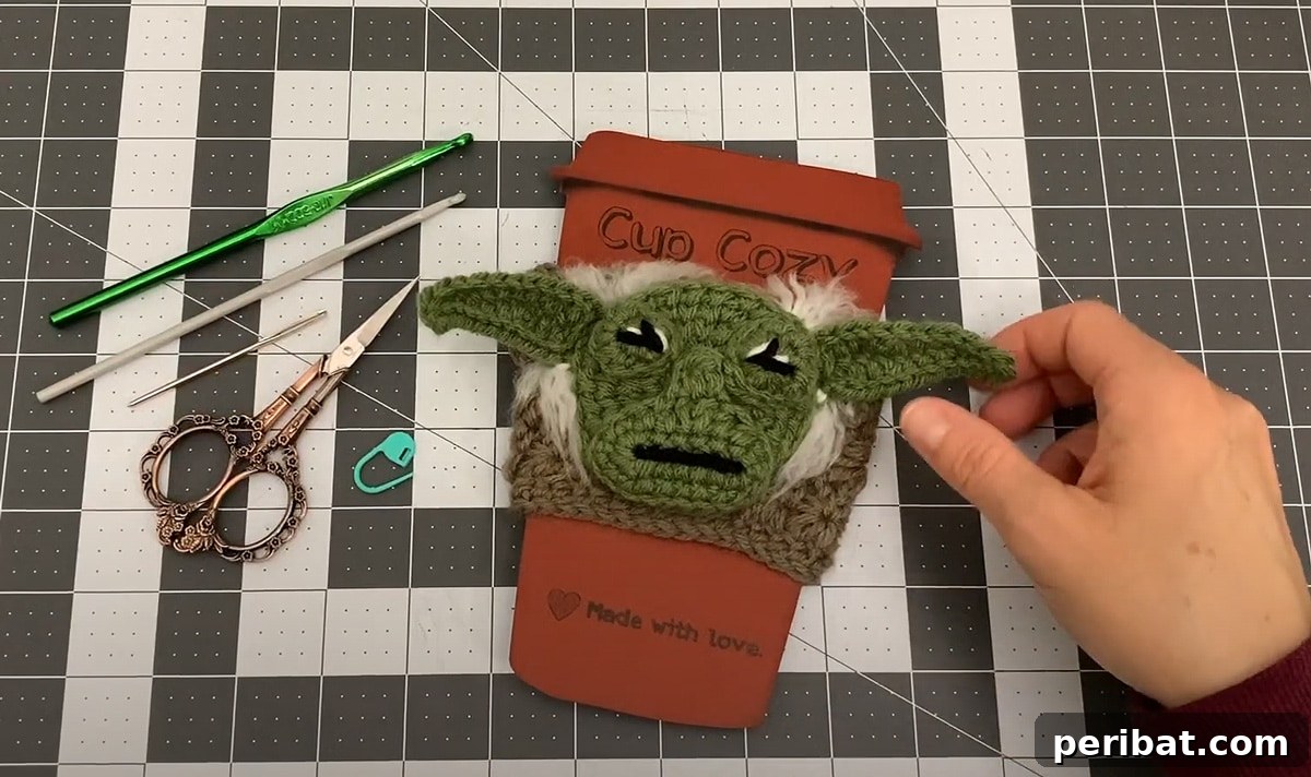 Unique Star Wars-inspired coffee sleeve featuring Yoda, a fun crochet project for fans