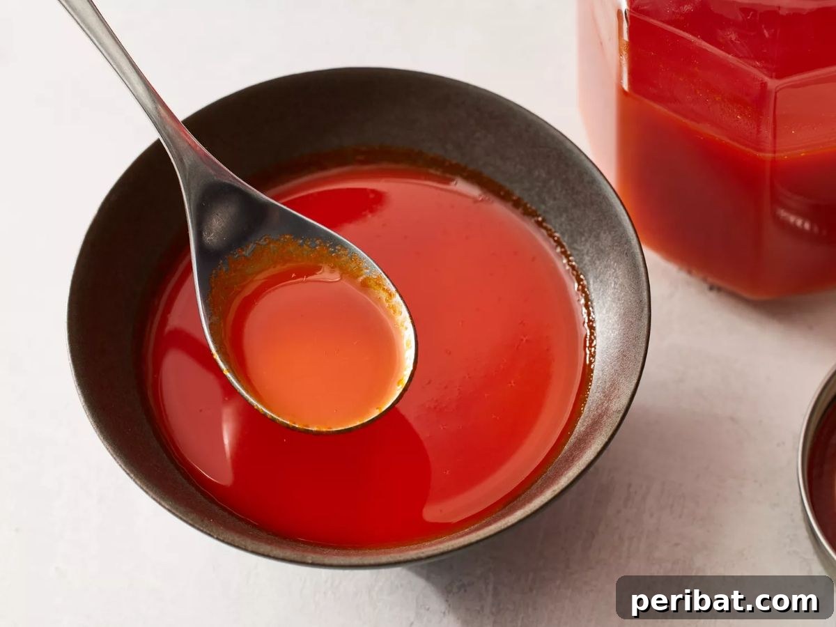 Craft Your Own Heat 26 DIY Hot Sauce Kits and Recipes 16 A bowl of freshly made Homemade Sriracha Sauce, showcasing its rich red color.