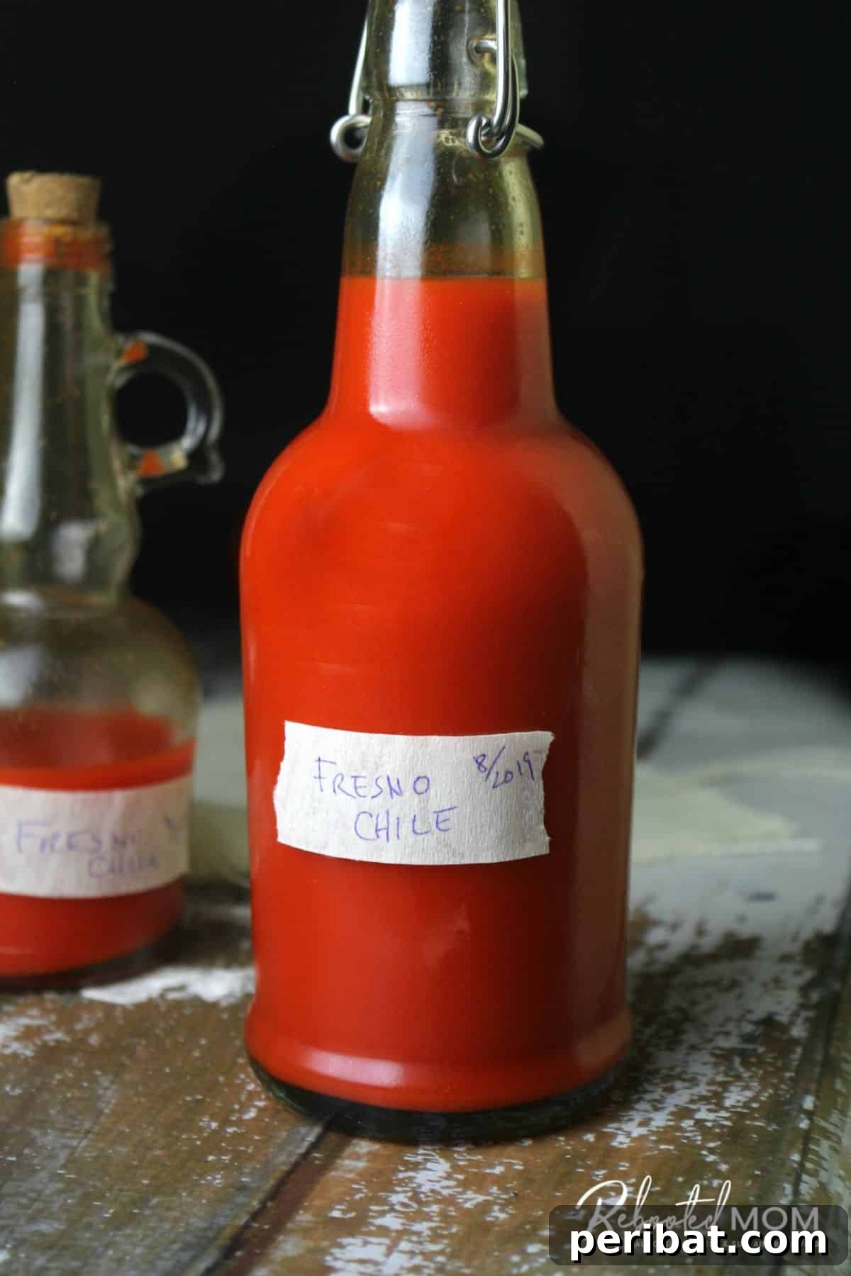 Craft Your Own Heat 26 DIY Hot Sauce Kits and Recipes 25 A glass jar of bubbling Fermented Fresno Pepper Hot Sauce, highlighting its probiotic nature.