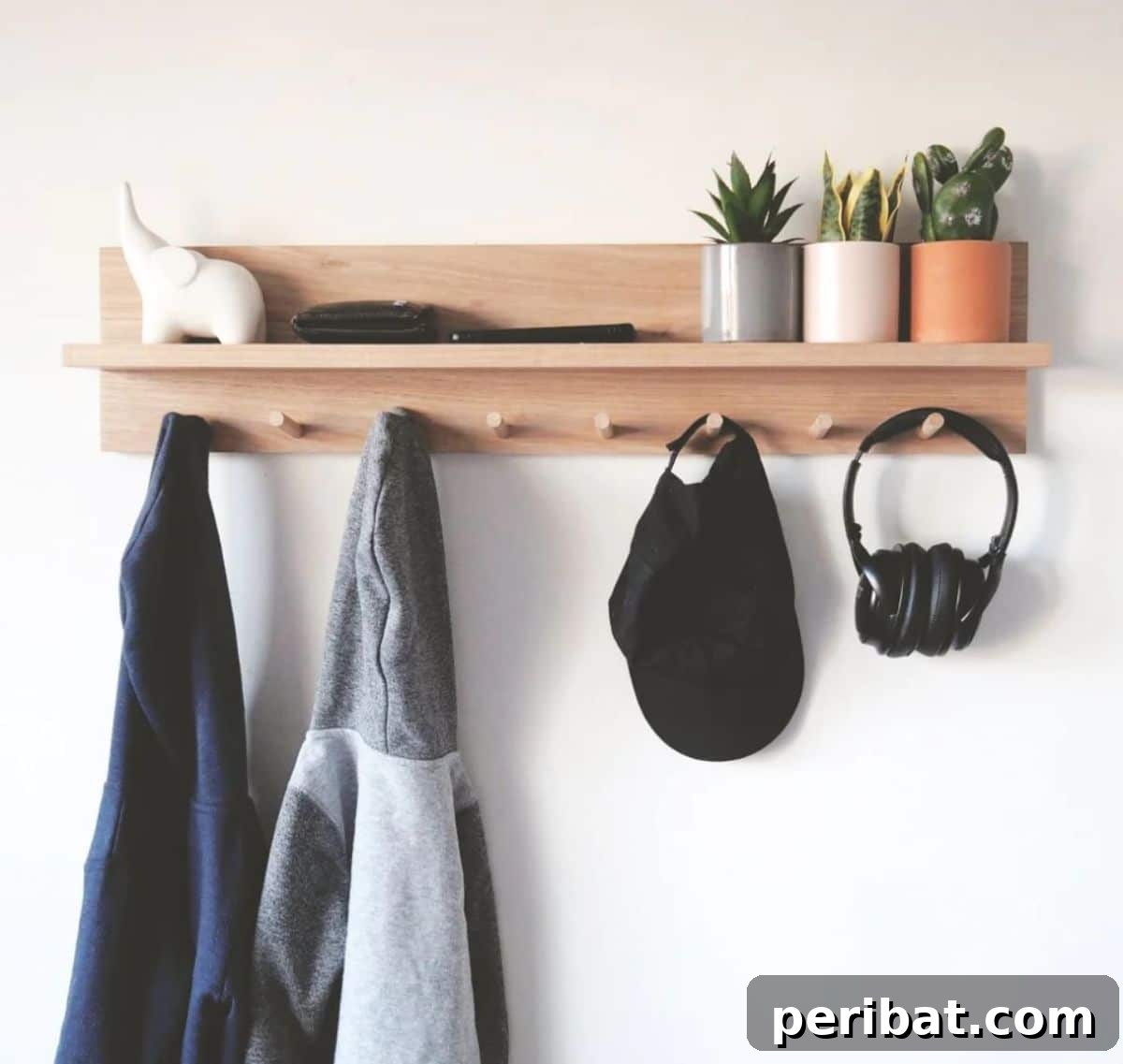 Transform Your Entryway: 32 Genius DIY Organizing Ideas 3 Stylish coat rack entryway organizer shelf with hooks and a top shelf for decor.