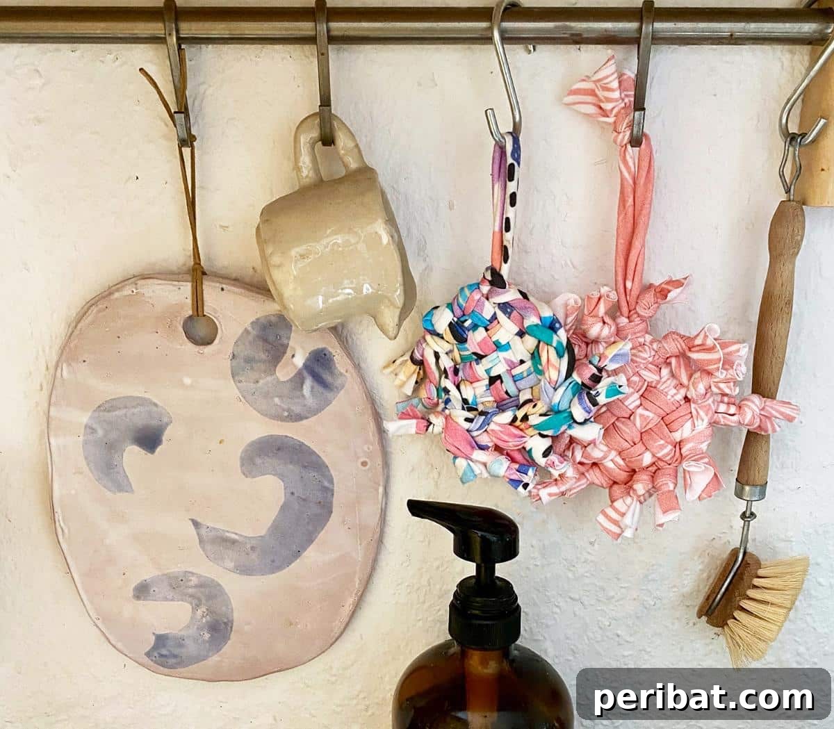 DIY No-Sew Zero-Waste Tawashi Sponge on an utensil rack.