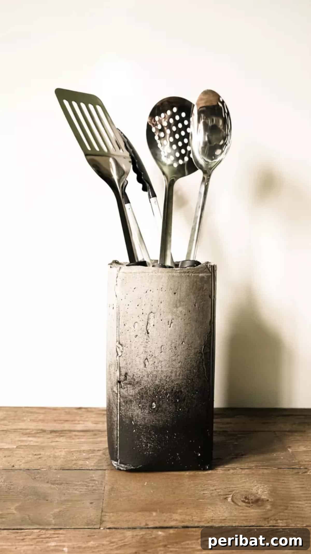 DIY Concrete Utensil Holder, an industrial art-inspired piece with hand-painted accents for modern kitchen decor.