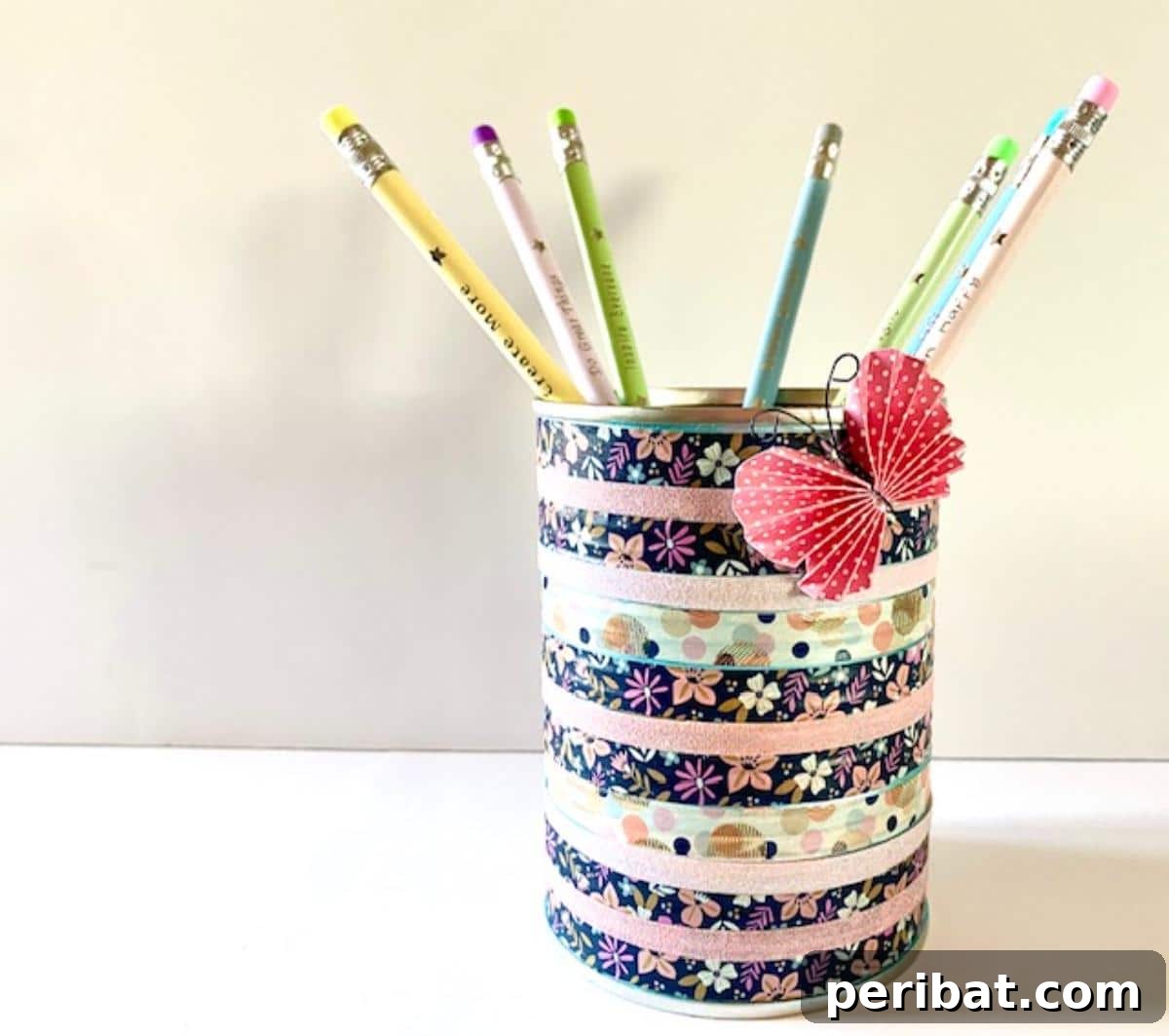 DIY Washi Tape Pencil Holder, an eye-catching craft using an empty metal can and colorful tapes, perfect for home or office.