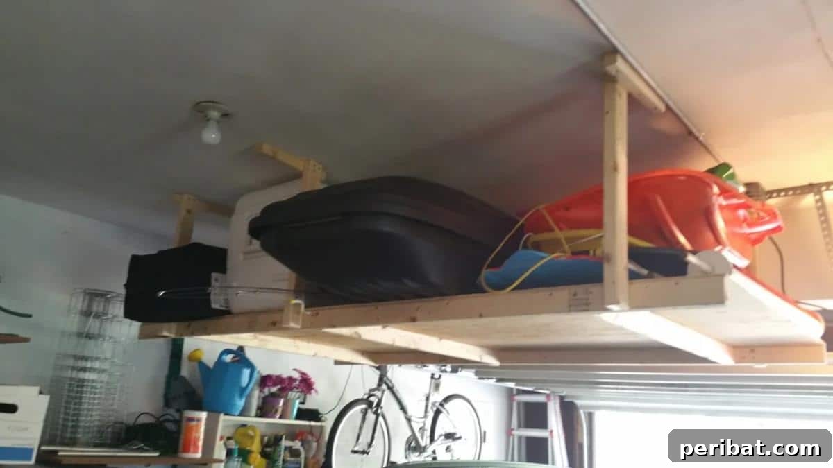 DIY Ceiling Extra Storage Shelves, showing robust wooden shelves suspended from the ceiling beams, efficiently holding large storage boxes.
