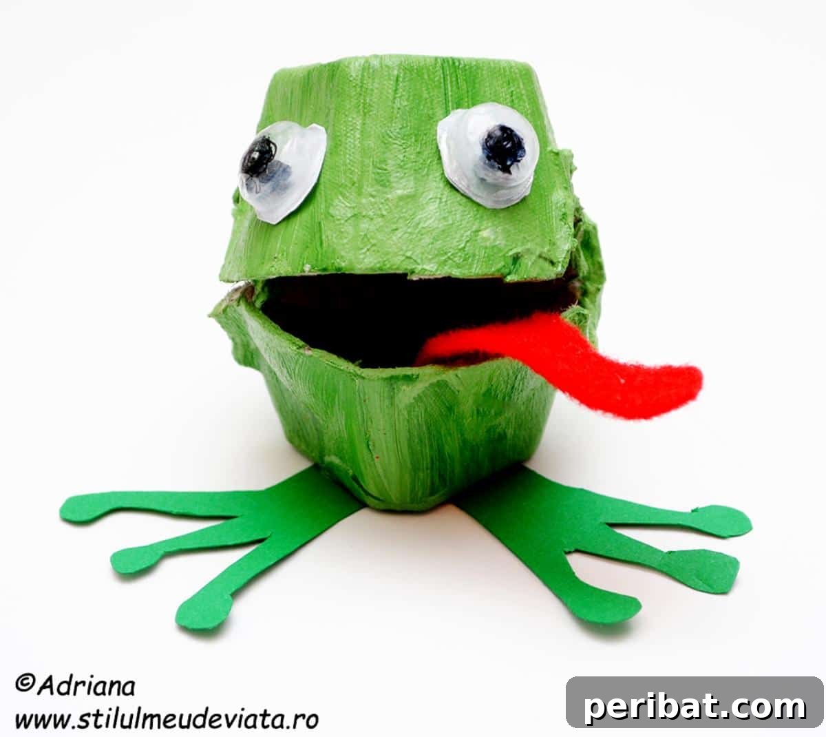 35 Mind-Blowing Creations from Empty Egg Cartons 16 An adorable green frog crafted from an egg carton, with large eyes and a red tongue sticking out, showcasing clever construction.