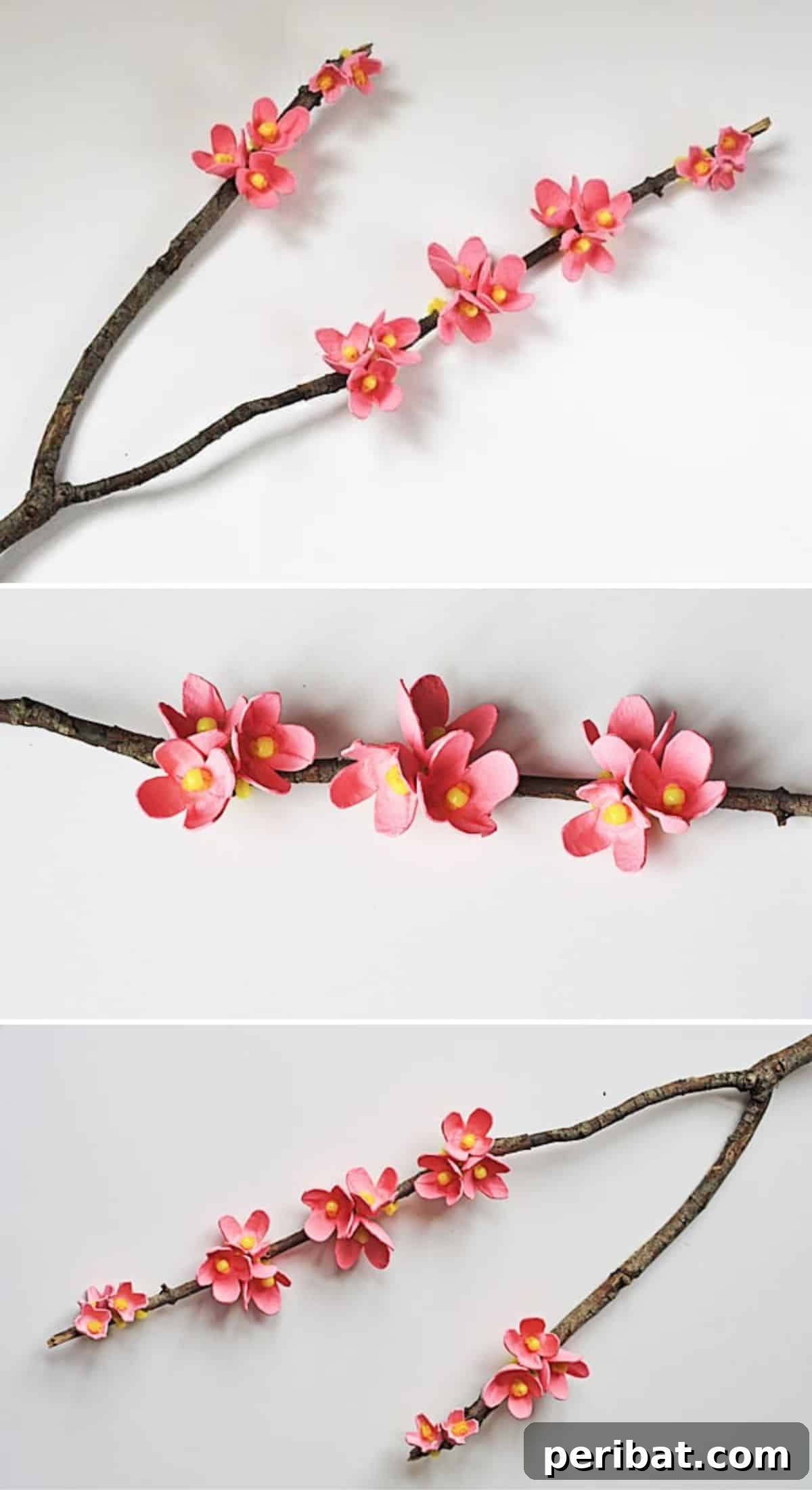 35 Mind-Blowing Creations from Empty Egg Cartons 3 Delicate cherry blossom branches crafted from egg cartons, featuring pink petals and yellow centers, arranged with natural tree branches.