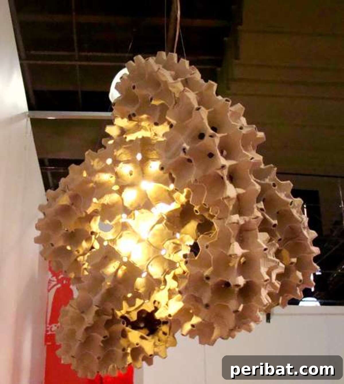 35 Mind-Blowing Creations from Empty Egg Cartons 26 A complex geometric lamp sculpture crafted from natural-colored egg cartons, resembling an organic, intricate form.