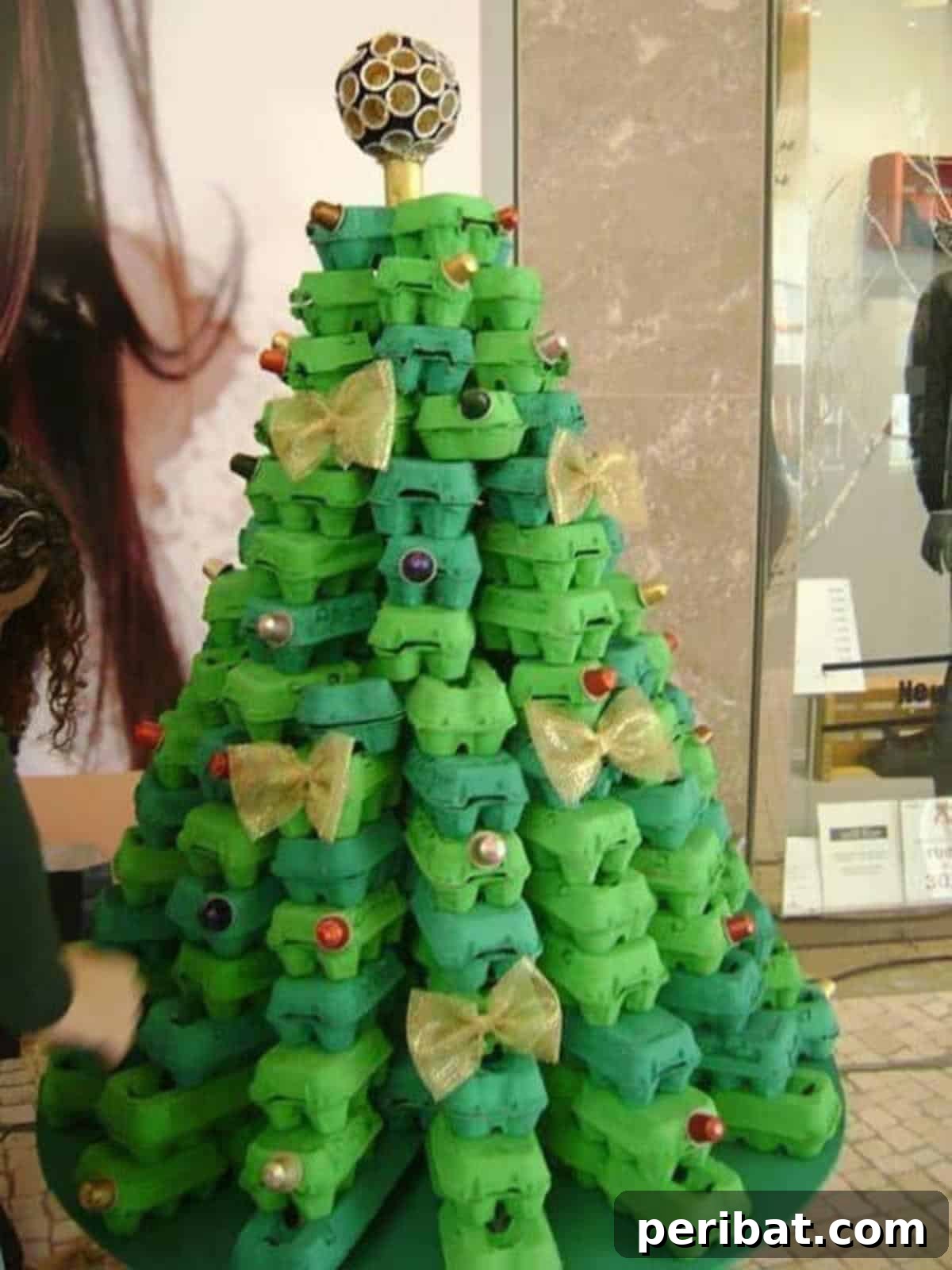 35 Mind-Blowing Creations from Empty Egg Cartons 30 An eco-friendly Christmas tree creatively constructed from stacked and painted green egg cartons, decorated with small ornaments.