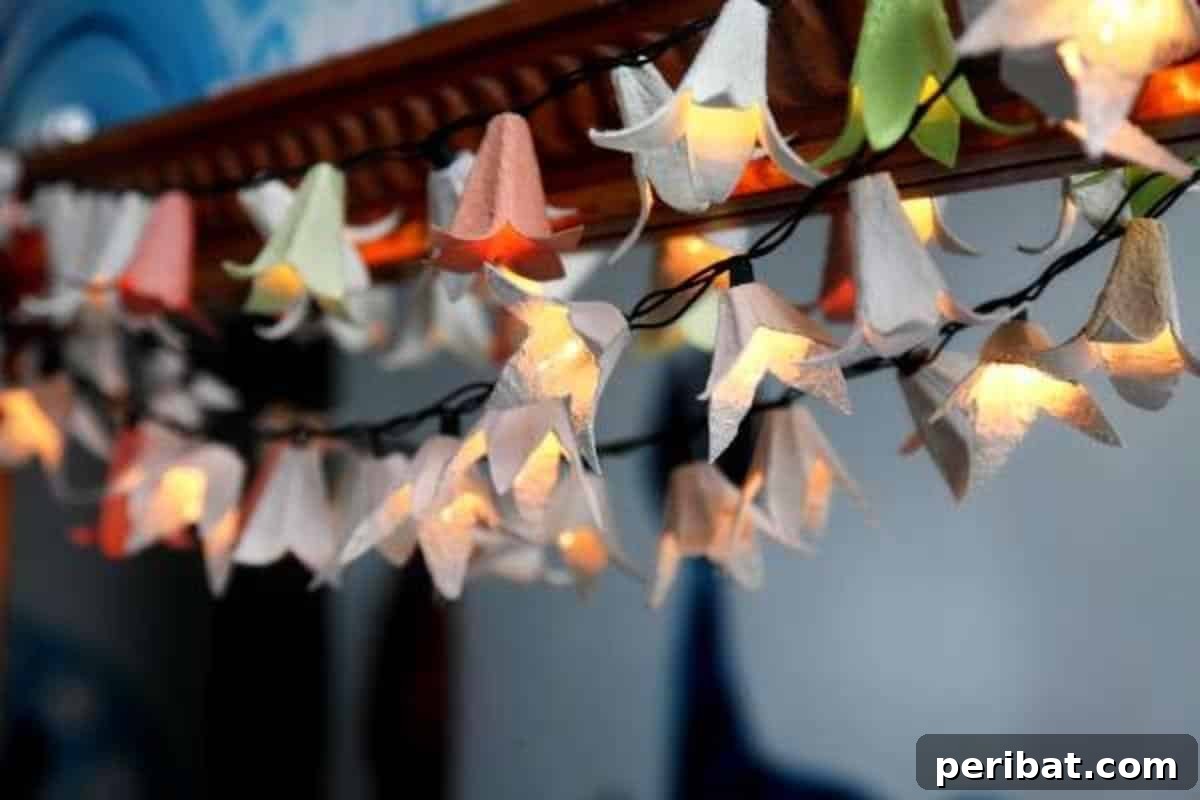 35 Mind-Blowing Creations from Empty Egg Cartons 4 A string of whimsical fairy lanterns made from repurposed egg carton flowers, casting a soft, enchanting glow against a dark background.