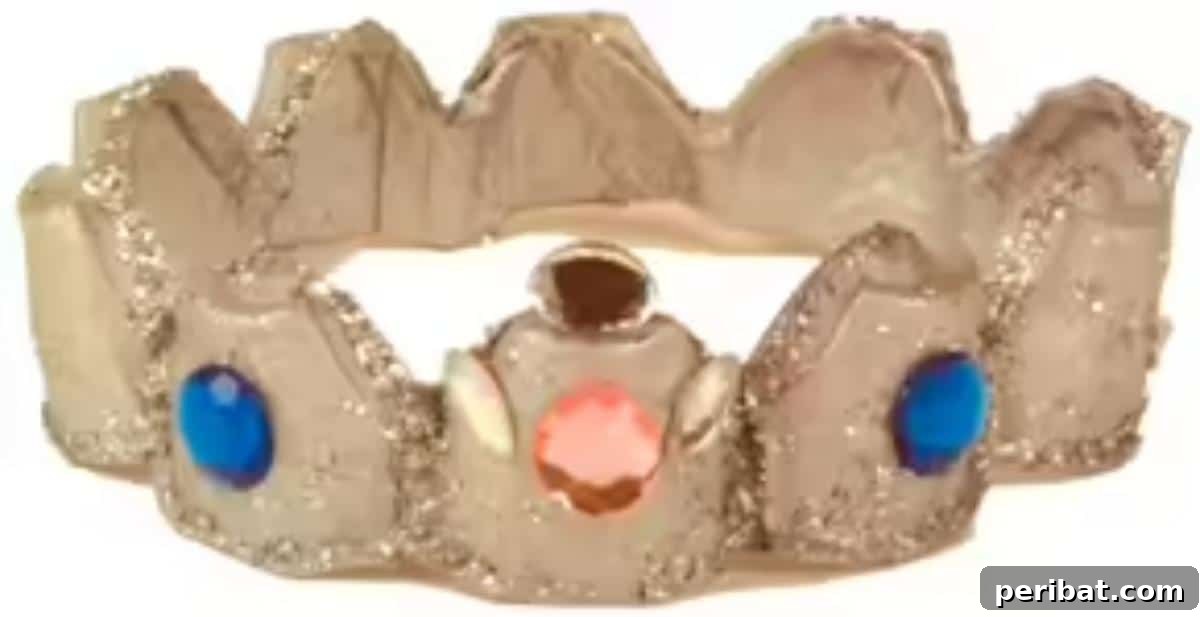 35 Mind-Blowing Creations from Empty Egg Cartons 31 A dazzling crown crafted from an egg carton, adorned with silver paint, faux gems, and glitter, fit for a prince or princess.