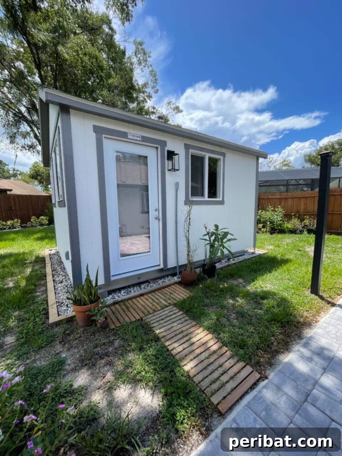Unlock Your Potential: 42 Inspiring Backyard Studio Shed Designs 11 An elegantly designed 'She Shed' backyard office, featuring stylish decor, comfortable seating, and a productive workspace.