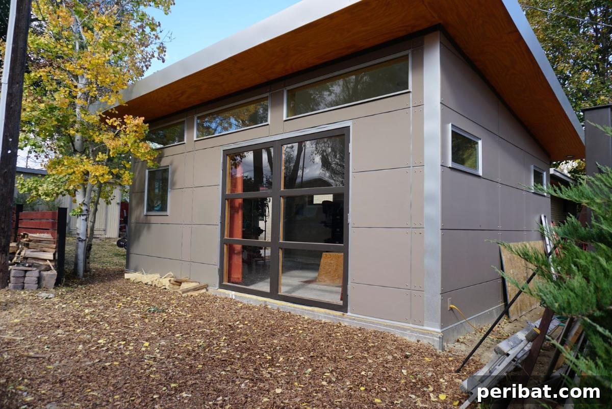 Unlock Your Potential: 42 Inspiring Backyard Studio Shed Designs 5 An elegant and sophisticated 'Fancypants Detached Studio' with a modern design, large glass doors, and a serene outdoor setting.