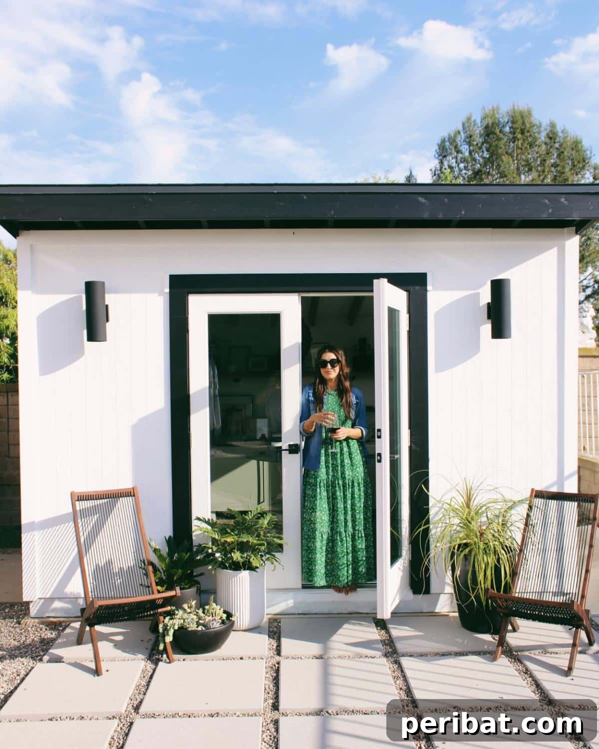 Unlock Your Potential: 42 Inspiring Backyard Studio Shed Designs 7 A quaint and charming little backyard studio shed, nestled amongst greenery with a cozy and inviting appearance.