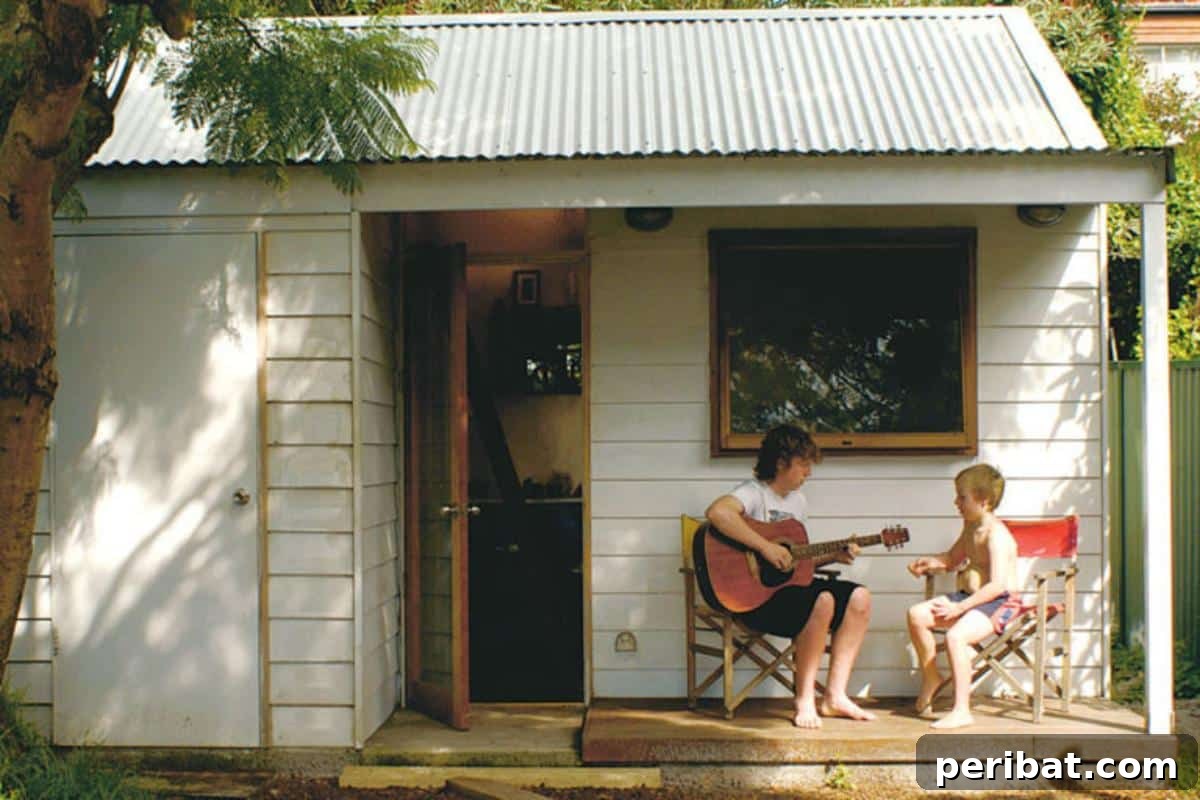 Unlock Your Potential: 42 Inspiring Backyard Studio Shed Designs 10 A charming backyard cabin, exuding rustic appeal with wooden siding and a cozy, inviting atmosphere.