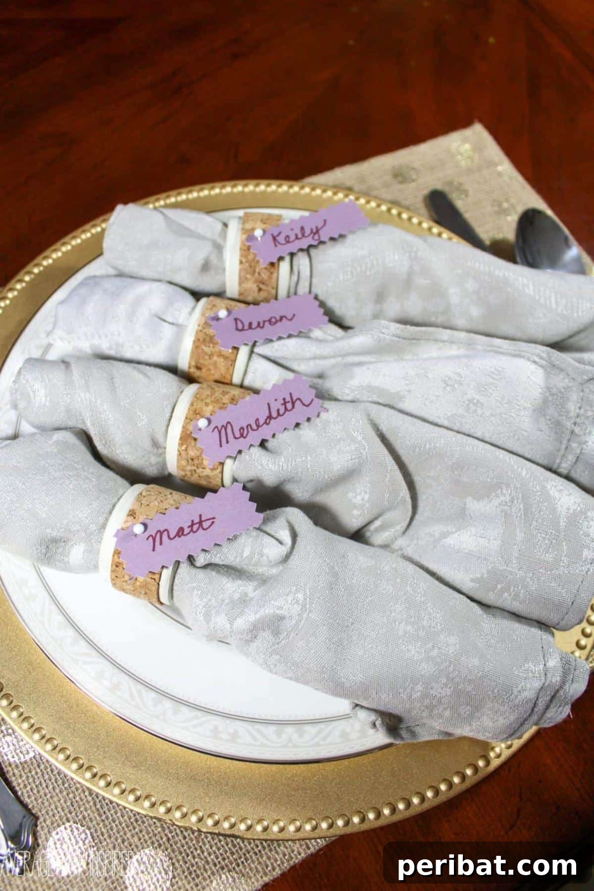 DIY Cork Napkin Ring Place Cards. Displays creative napkin rings made from repurposed wine corks, doubling as place card holders, offering a rustic and sustainable touch.